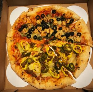 One side with vegan chicken and black olives, the other with banana peppers, vegan beef, artichokes and jalapeños.  at Chattanooga Pizza Co in Chattanooga