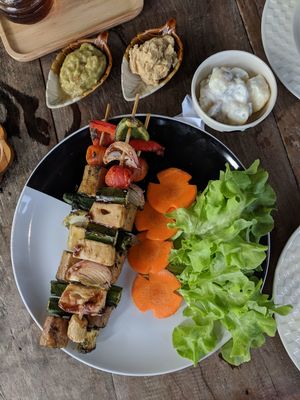 Kebabs with potato salad, hummus, and guac on the side at Full Moon Wellness Cafe in Chiang Rai