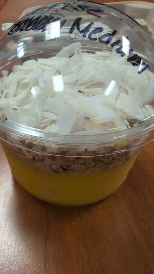 Mango Tango Sunrise with added coconut flakes at Raw Juice Cafe in Flagler Beach