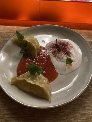 Pineapple gyoza dessert served with raspberry coulis and coconut and almond cream   at Marclee in Paris