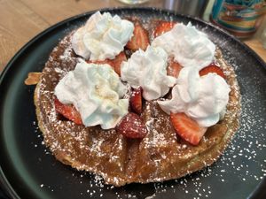 Waffles with seasonal fruit (strawberry)  at Bravocados in Tofino