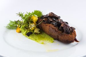 Pan seared Veggie steak made with lentils and chickpeas served with mushroom sautee and corn puree at Herbario in Medellin