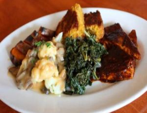 Vegan soul food plate: BBQ organic tofu steak served with vegan & gluten-free corn bread topped with cauliflower flowerets at Hugo's Restaurant - Studio City in Studio City