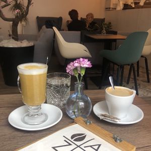Curcuma latte and coffee with plantbased milk. at Kavarna Oaza in Celje