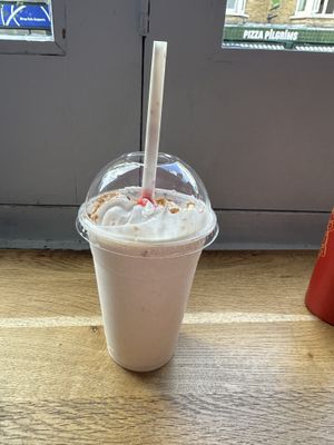 The large strawberry cheesecake milkshake with whipped cream; this was the highlight, it was so thick and creamy 🤤 I’d already started to drink it before taking this photo  at Temple of Seitan - Camden in North West London