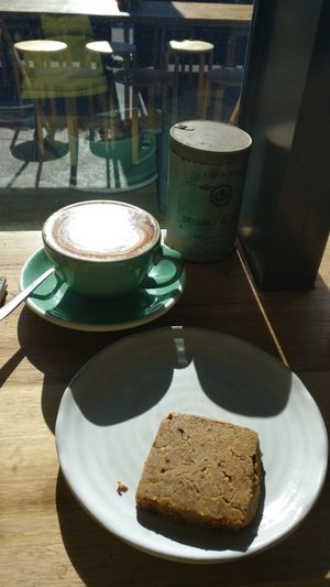 Enjoying sunshine from inside, with coffee and vegan shortbread at Small Graces in Footscray