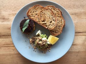 Meal of sides: sourdough toast with smashed avo, almond feta and dukkha as well as a sweet potato and coconut fritter with chilli jam at Small Graces in Footscray