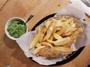 huge portion fish and chips and mushy peas at Sutton and Sons in North London