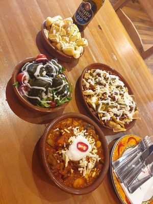 Nachos, stuffed vine leaves, veg chilli and patatas con vegan aioli at Tapas Tree in Bradford