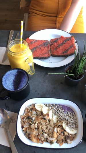 Blueberry muffin smoothie bowl with vanilla latte and strawberry and pineapple jam on toast with solar fusion smoothie  at Eight - The Health Lounge in Lisbon