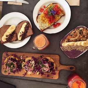 Almond butter toast, scrambled tofu & dill/cashew cheese toast, blueberry muffin bowl, selection of vegan tacos, 2 juices at Eight - The Health Lounge in Lisbon