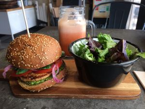 Burger with salad and pink lemonade juice at Eight - The Health Lounge in Lisbon