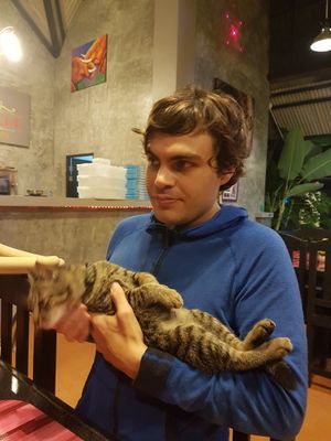 Playing with the furry resident at Bouganville Pizzeria in Ao Nang