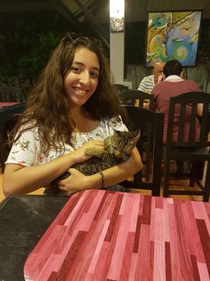 Playing with the furry resident at Bouganville Pizzeria in Ao Nang