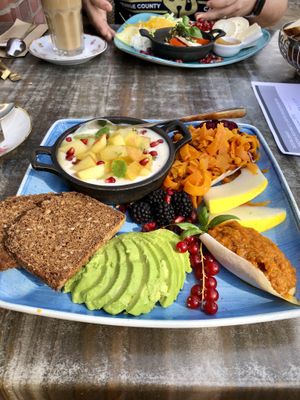 Vegan breakfast, fresh fruits on soy Joghurt, marinated carrots, whole grain  bread with perfect avocado and a delicious tomato spread.  at Anna's Cafe in Lueneburg