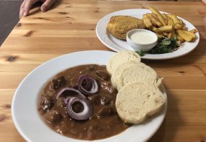 Beer goulash and vegan fried cheese served with tatar sauce  at Střecha in Prague