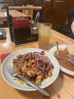 Poutine w/ jackfruit, lemon lemonade,  dark beer goulash  at Střecha in Prague