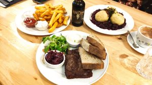 Ribs in plum sauce, fries with tris of dips, and dumplings on red cabbage at Střecha in Prague