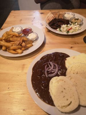 Dinner for two.. Goulash with dumplings, Seitan Kebab plate and chips with three dips at Střecha in Prague