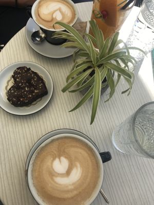 Coffee with vegan milk and a vegan brownie at Cajnica Vanilla in Koper