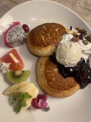 Pancakes with fruits, ice cream, cream and black currant sauce + some nuts and seeds.  at AIN SOPH.Journey in Kyoto