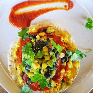 Rancheros - Corn tortilla, scrambled tofu, rancheros sauce and black bean, corn and avocado salsa.
 at The Butcher's Son in Auckland