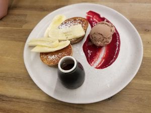Banana pancakes with coconut ice cream and berry coulis. at The Butcher's Son in Auckland