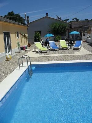 Enjoy relaxing with a book by the pool, or go for a swim. at Casa Das Flores in Tomar