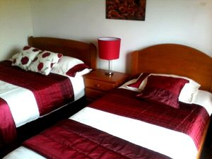 The poppy room, double bed and single bed with balcony at Casa Das Flores in Tomar