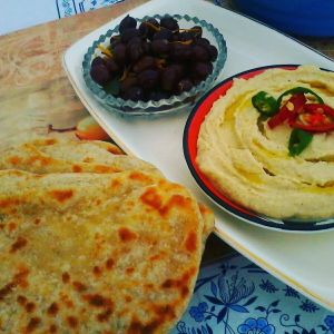 Homemade flat breads with hummus and marinated olives at Casa Das Flores in Tomar