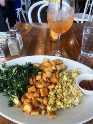Breakfast platter with garlicky greens, crispy potatoes, and tofu scramble  at SEA - Floret in Seattle