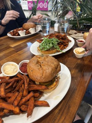 We got the Spicy Tofu Sandwich and the Black Bean Burger! The vegan aoli + bun were SO GOOD! Fair price for airport burgers - our family of 4 were very happy! Massive fry pile!!  at SEA - Floret in Seattle
