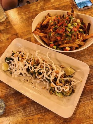 XO Broccoli and Butter Chicken Poutine  at MeeT in Yaletown in Vancouver