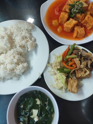 Rice plate (front) and tomato tofu (back) at Huyen Trang in Da Nang