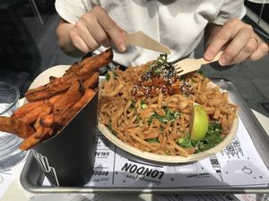 Spicy Thai salad with a side of oven baked sweet potato fries at By Chloe - Tower Bridge in London