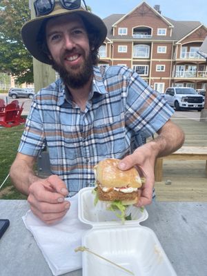 Ian with his Crispy Jerk sandwich. at Stir It Up in Charlottetown