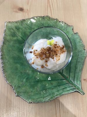 Mousse de coco con frutos secos y flor at O Macrobiotico in Porto