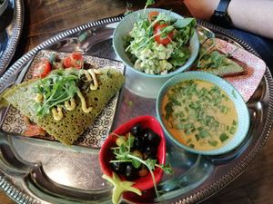 Buckwheat pancake, Tom kha soup with avocado bread, and salad at Mazā Terapija in Riga