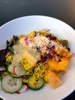 Red bean bowl with baked pineapple, bell peppers, corn, herbal rice and peanut sauce at Mazā Terapija in Riga