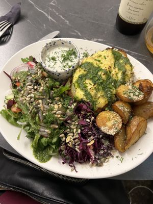 Huge portion of schnitzel with baked potato  at Mazā Terapija in Riga