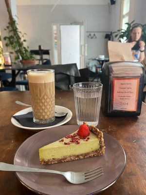 Avocado cake and cafe latte. at Mazā Terapija in Riga