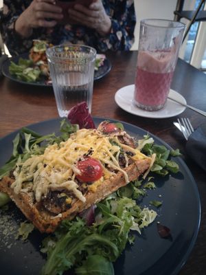 Breakfast waffle (closest) and carrot salmon waffle with raspberry chai latte at Mazā Terapija in Riga
