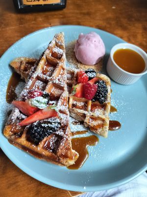 Belgian waffles with powdered sugar at Mazā Terapija in Riga