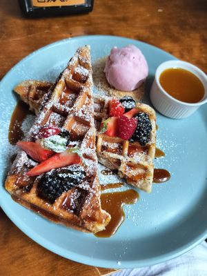 Belgian waffles with powdered sugar at Mazā Terapija in Riga