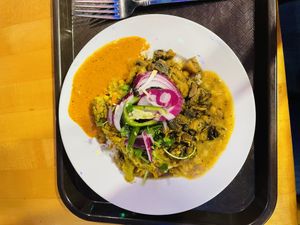 Rice bowl with half lentils and various toppinggs  at Bridges Nepali Cuisine - Northside in Cincinnati