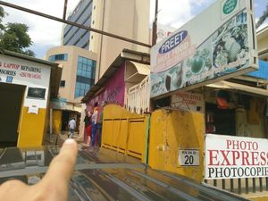 Follow this man to find the restaurant. at Preet Fast Food in Kigali