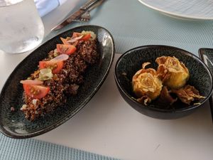 Vegan warm quinoa salad and deep-fried artichoke hearts with lemon zest crust... Both so delicious. at Azur - Four Seasons Hotel in Tunis