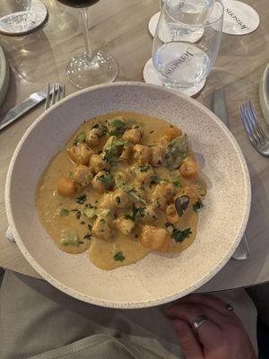 Gnocchi with Jensens red curry sauce, fresh herbs and coconut crunch (GF)  at Jensens in Kareela