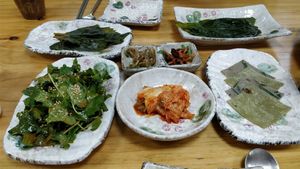 Perilla, wild garlic, angelica root, seasoned dried radish, kimchi, salad herbs in chilli sesame sauce and buckwheat pancakes at Mountain Veg Table in Gangreung