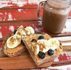 Breakfast - Pics Nut Butter with banana and Blueberries on sourdough bread + H5 Smoothie at Gre3n Superfood & Juice Bar - Ferrymead  in Christchurch